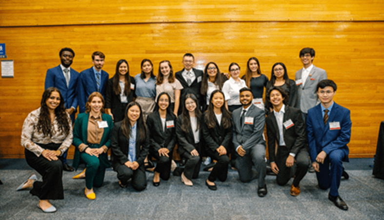 Team in suits posing in gymnasium