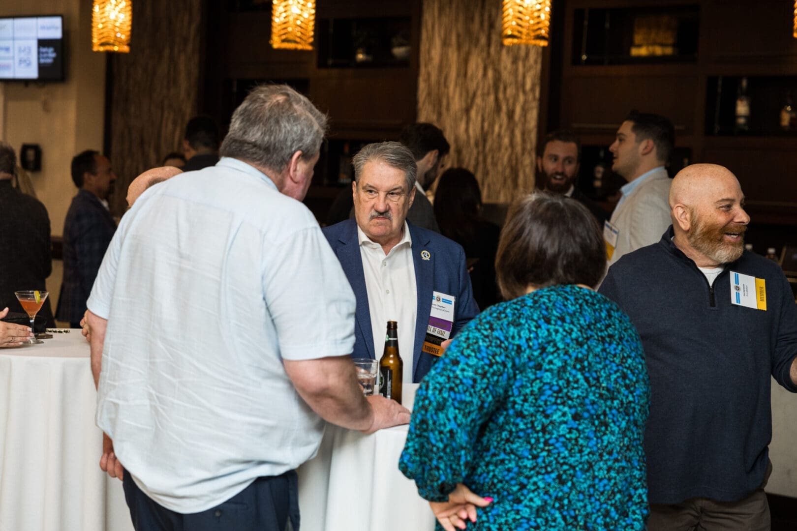 A group of people are networking at a conference.