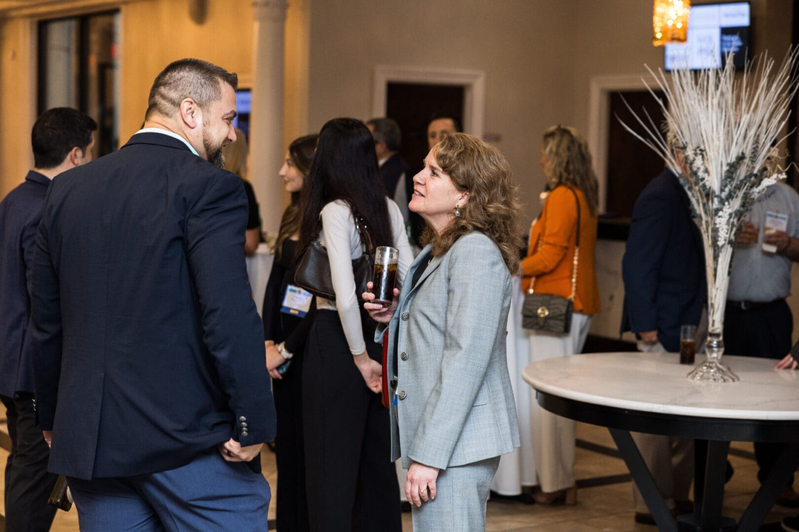 Two business professionals talking at a conference.