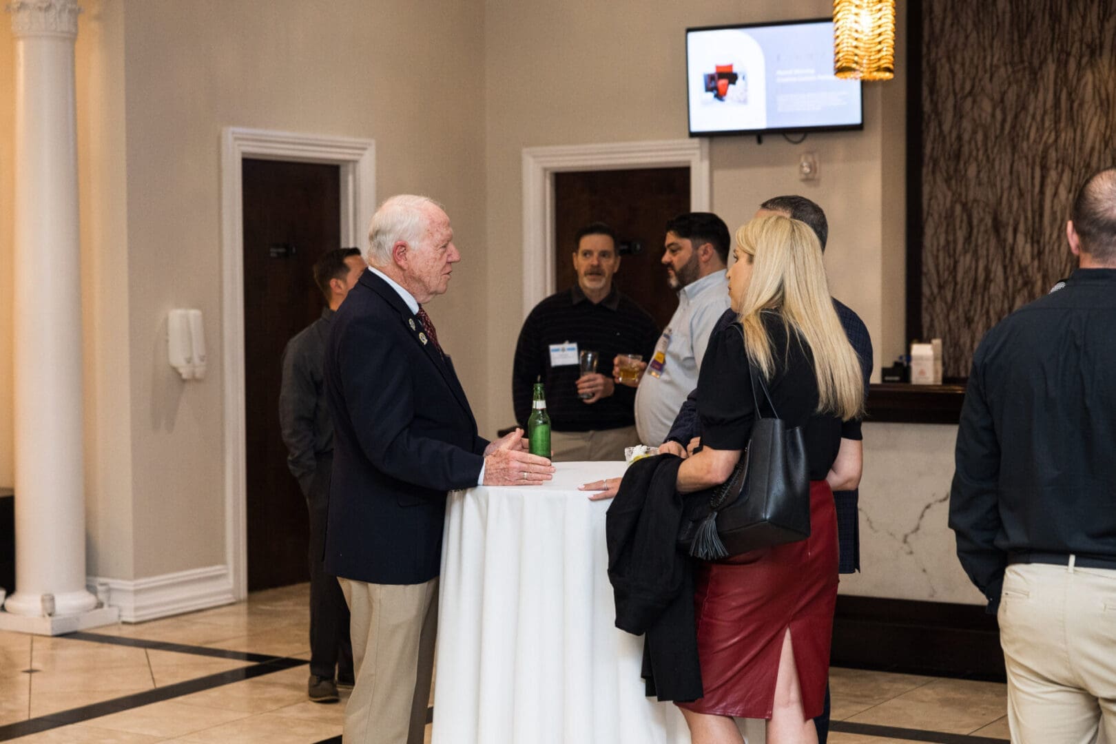 A group of people are talking at a conference.