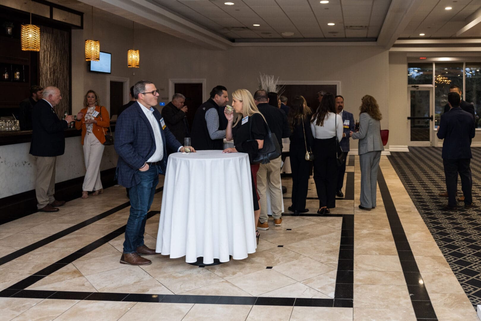 People talking and drinking at a business conference.