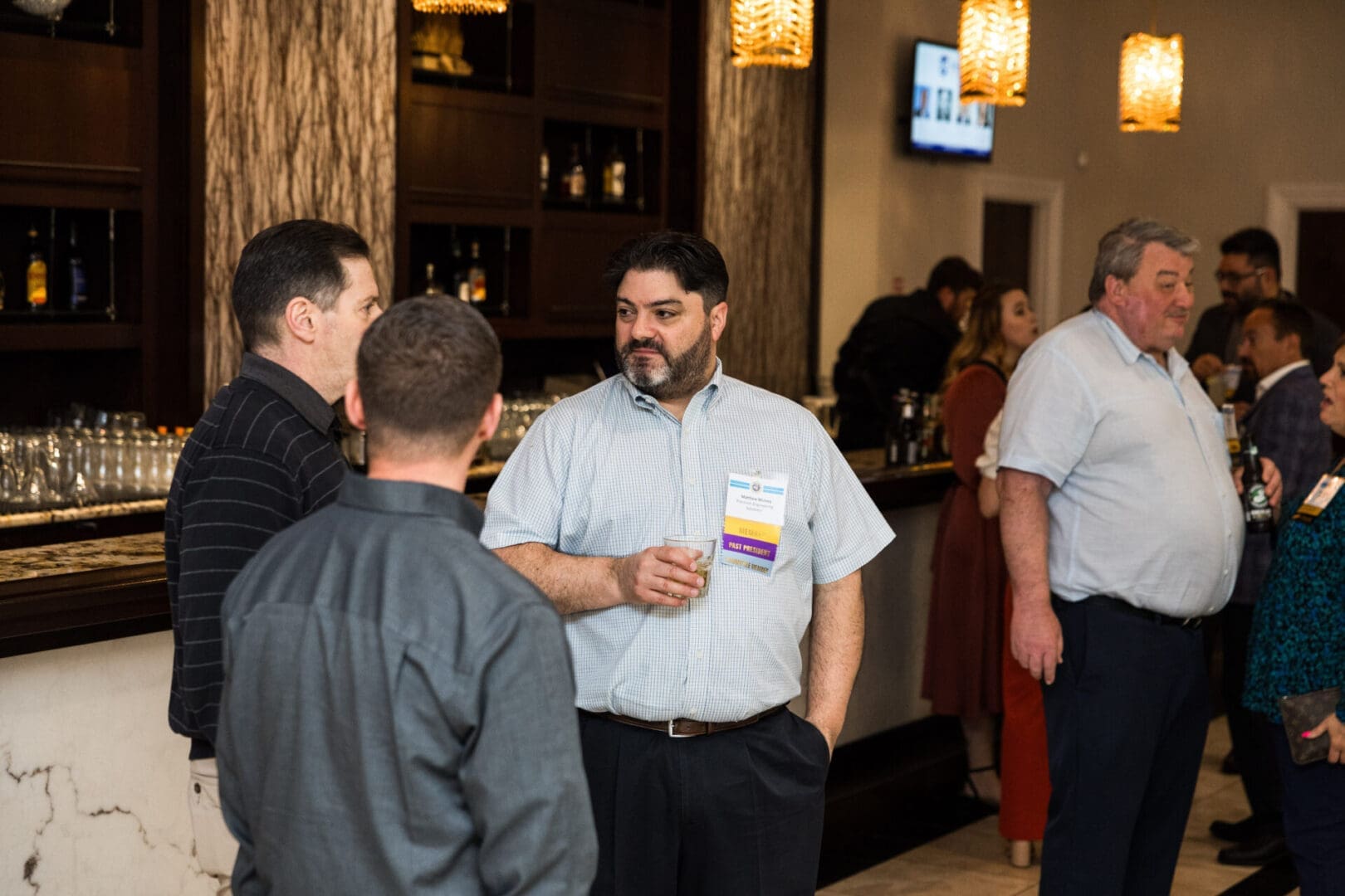 Businessmen talking at a networking event.