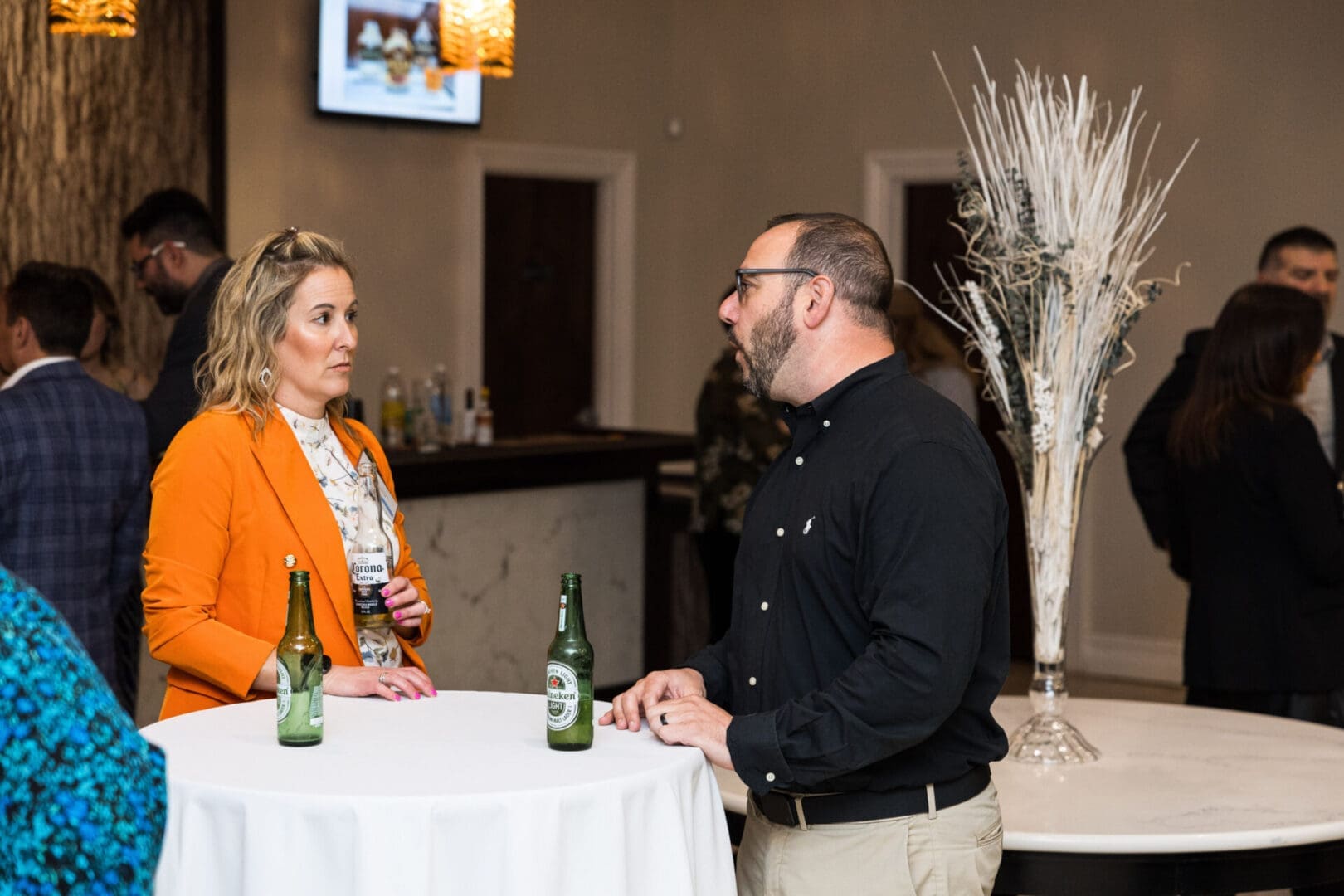 Two people talking at a business event.