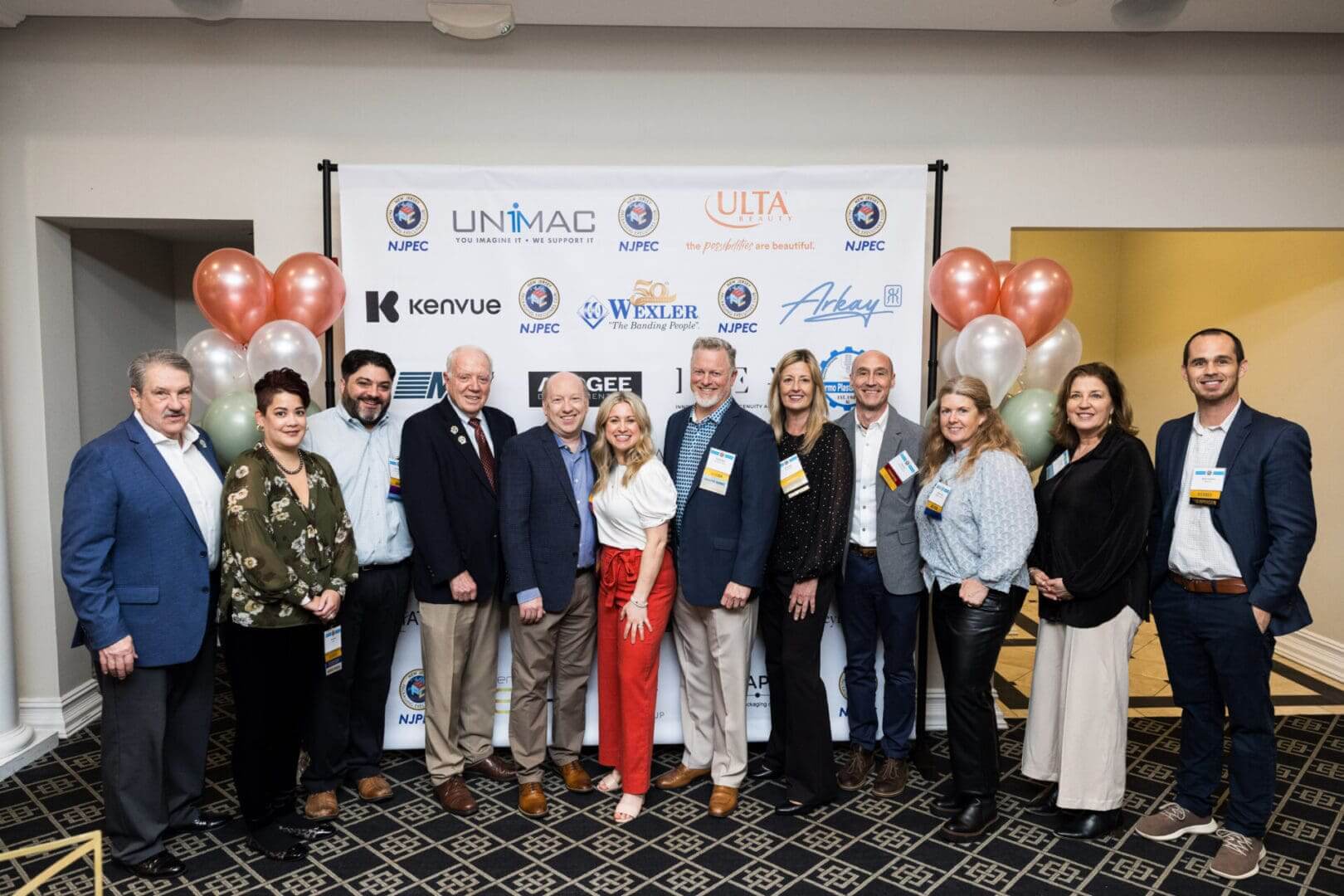 A group of people posing for a photo at an event.