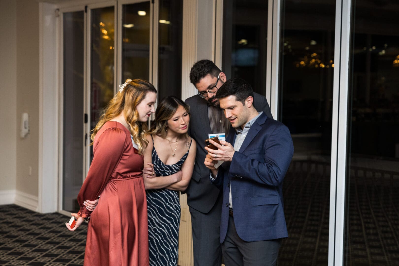 Group of people looking at a smartphone.