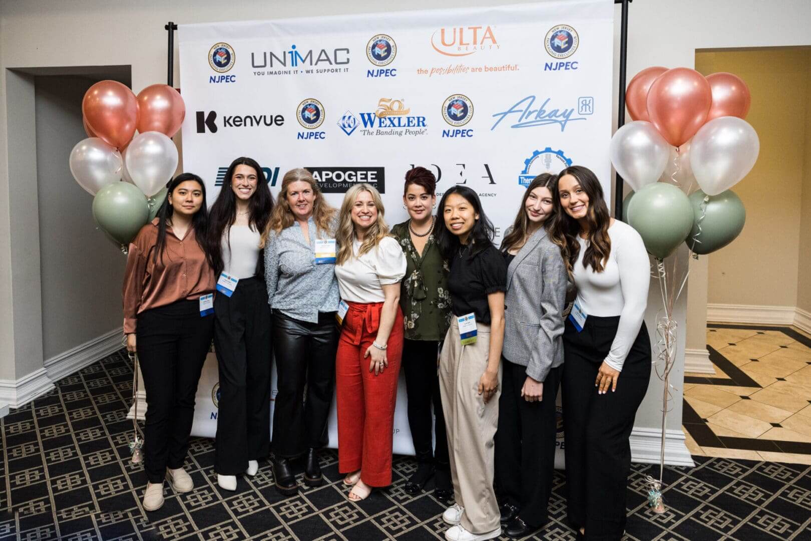 A group of women posing at a conference.