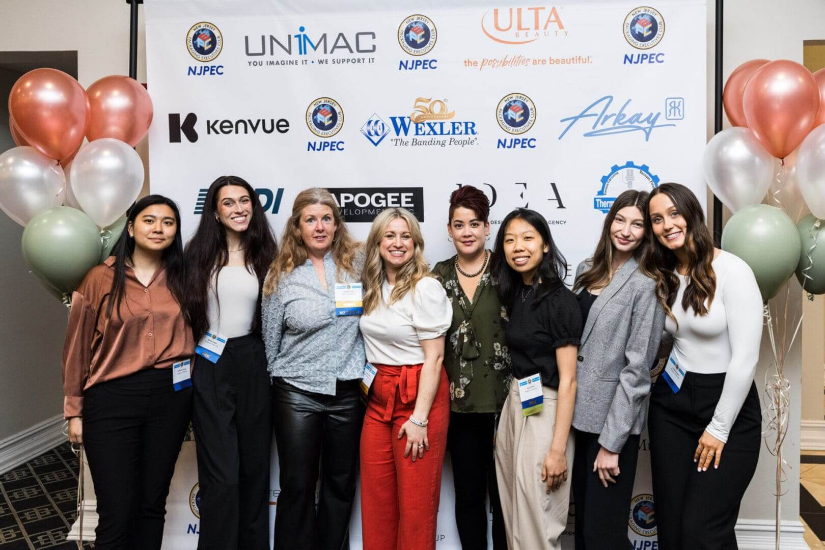 A group of women posing at a conference.