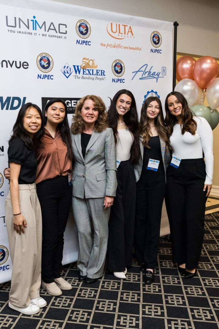 A group of six people posing for a photo at an event.