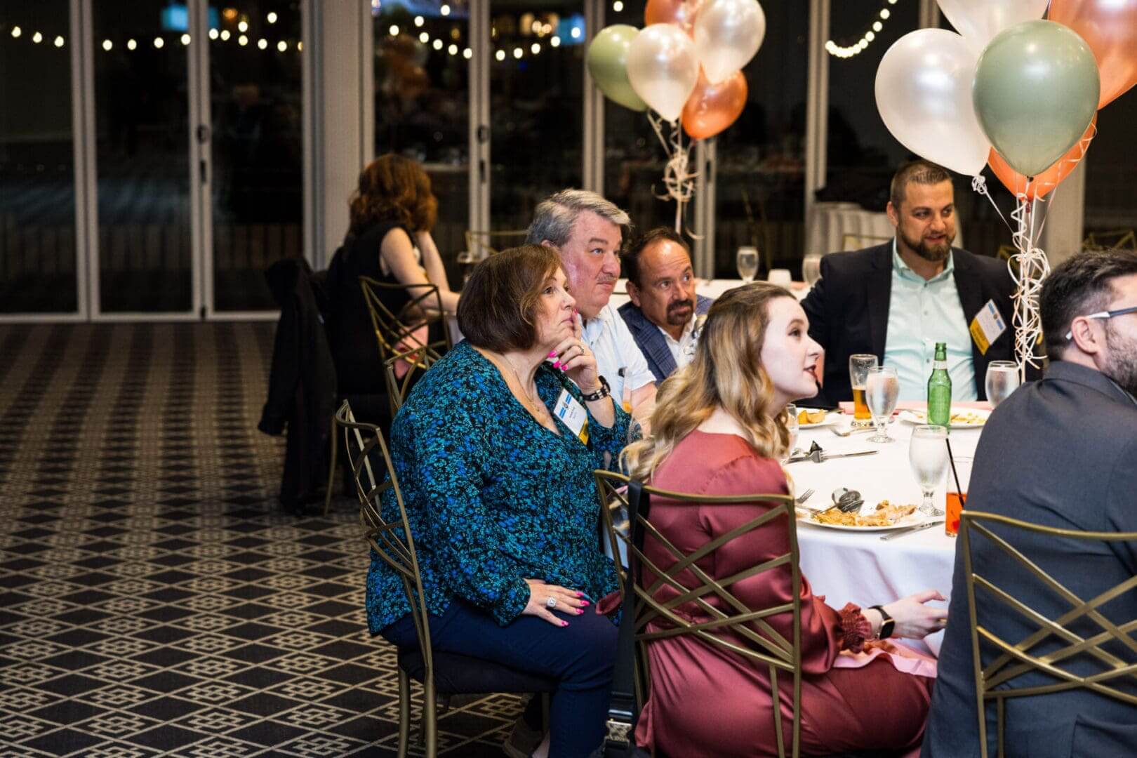 A group of people are sitting at a table and talking.