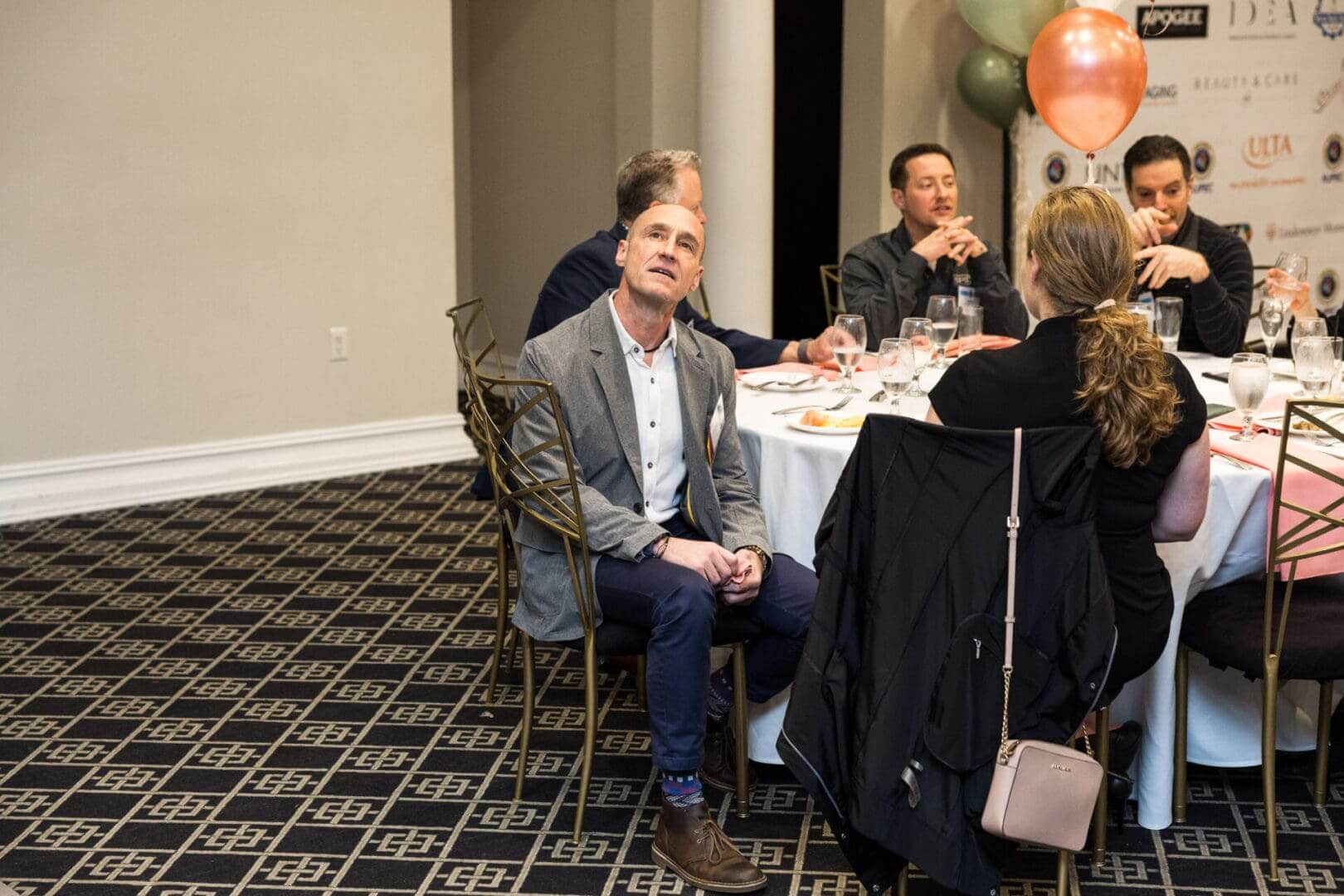 A man and woman are talking at a conference.