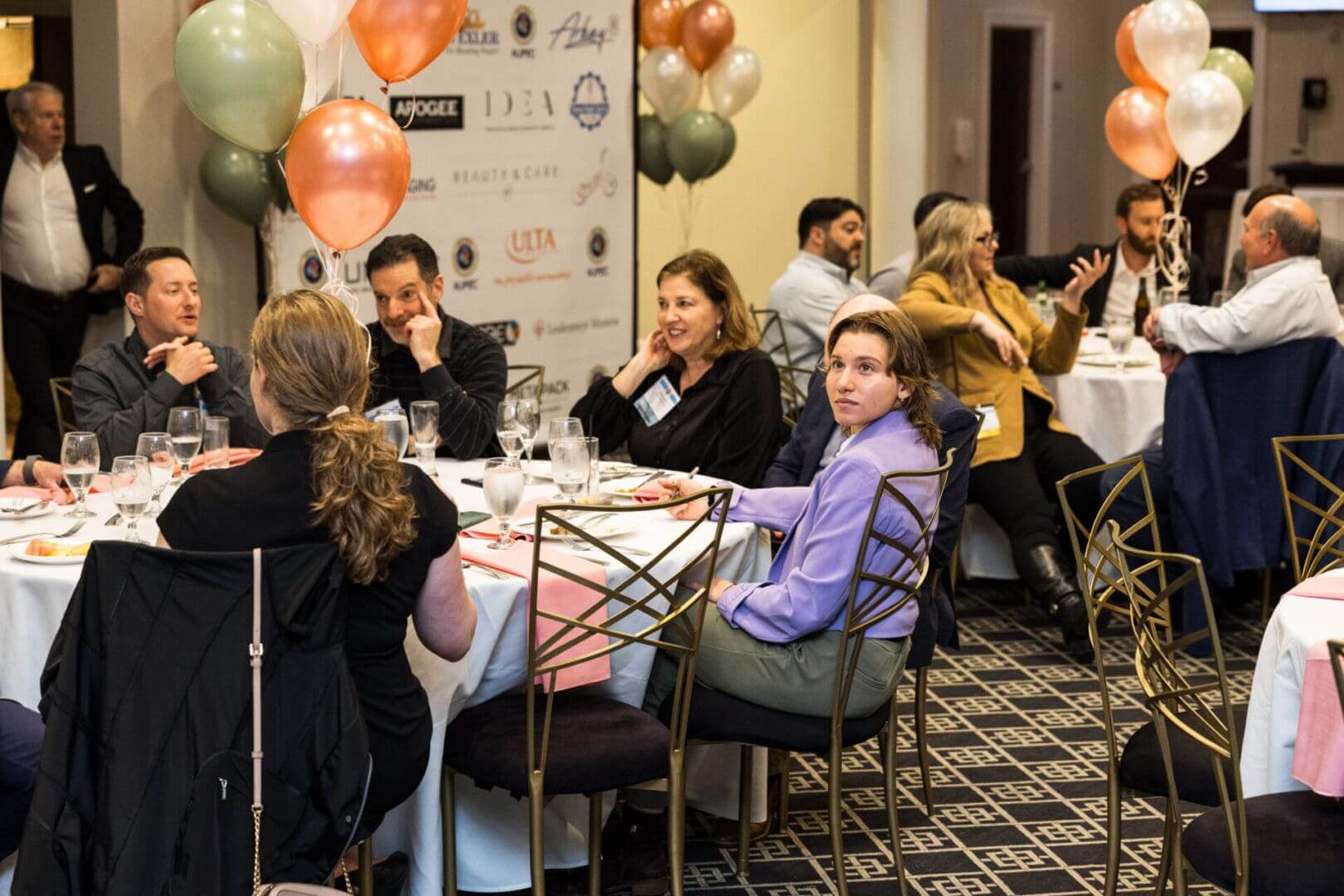 A group of people are sitting at tables in a room.
