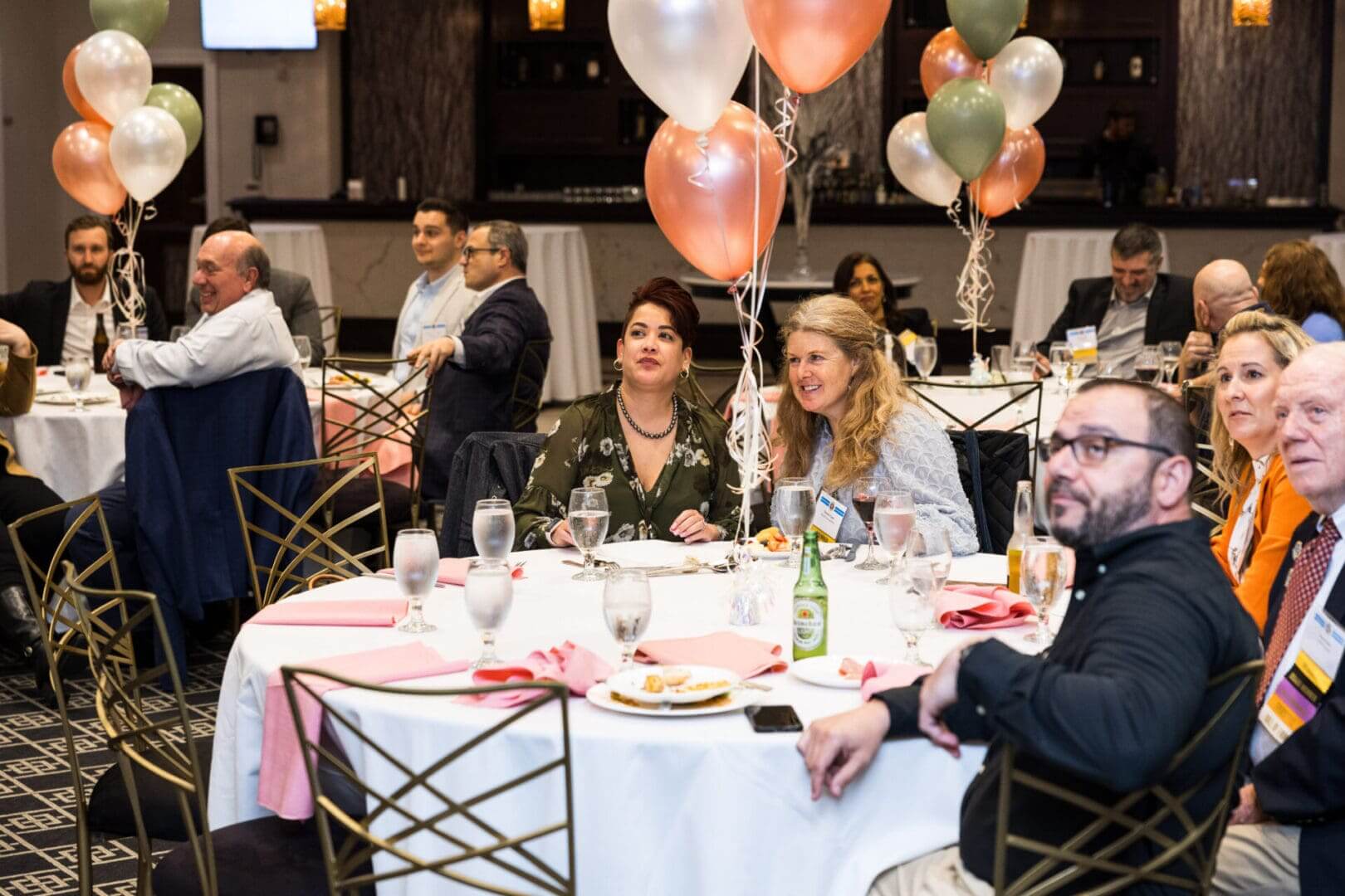 Business people at a conference listening to a speaker.