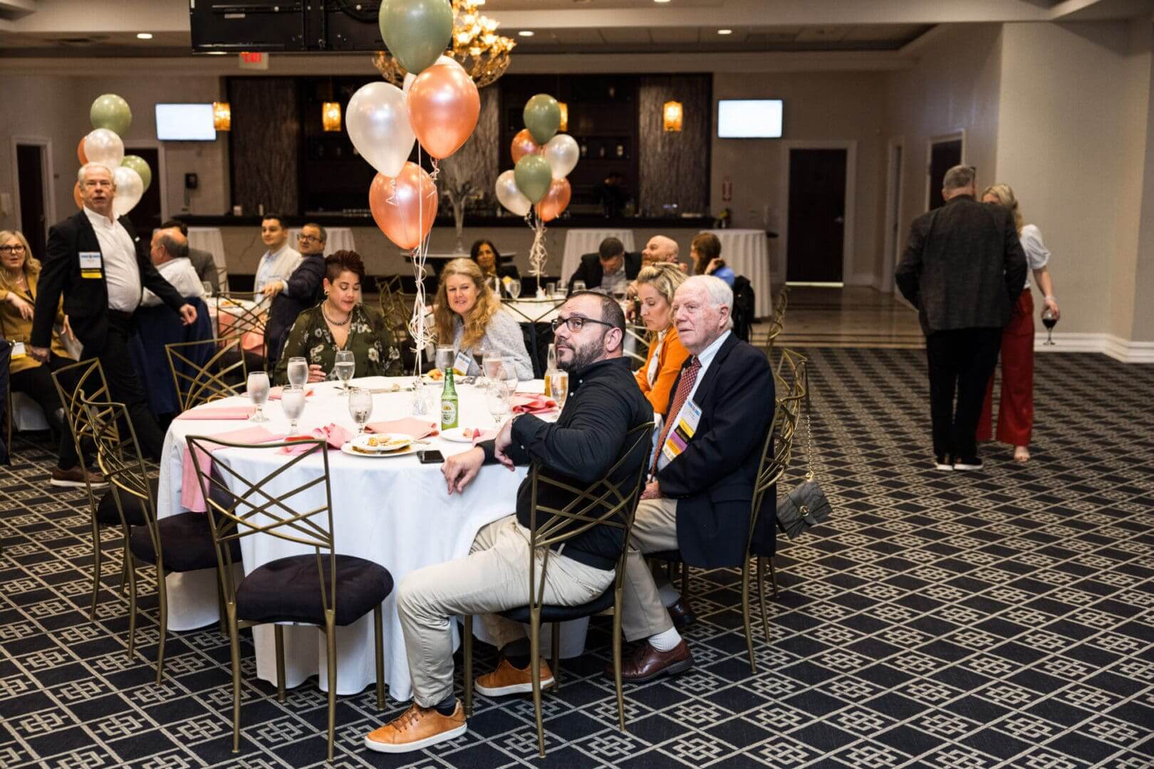 A group of people are sitting at a table in a room.