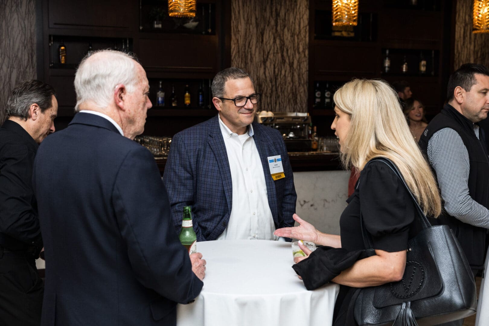 A group of people are networking at a business event.