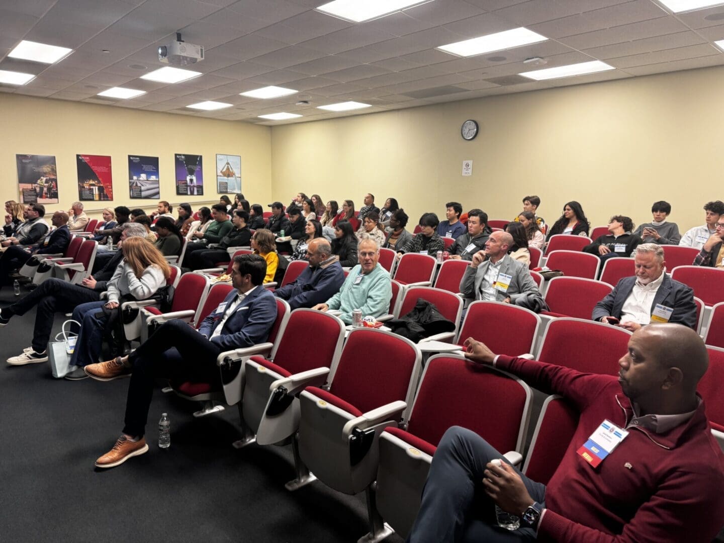 Audience seated in a conference room setting.