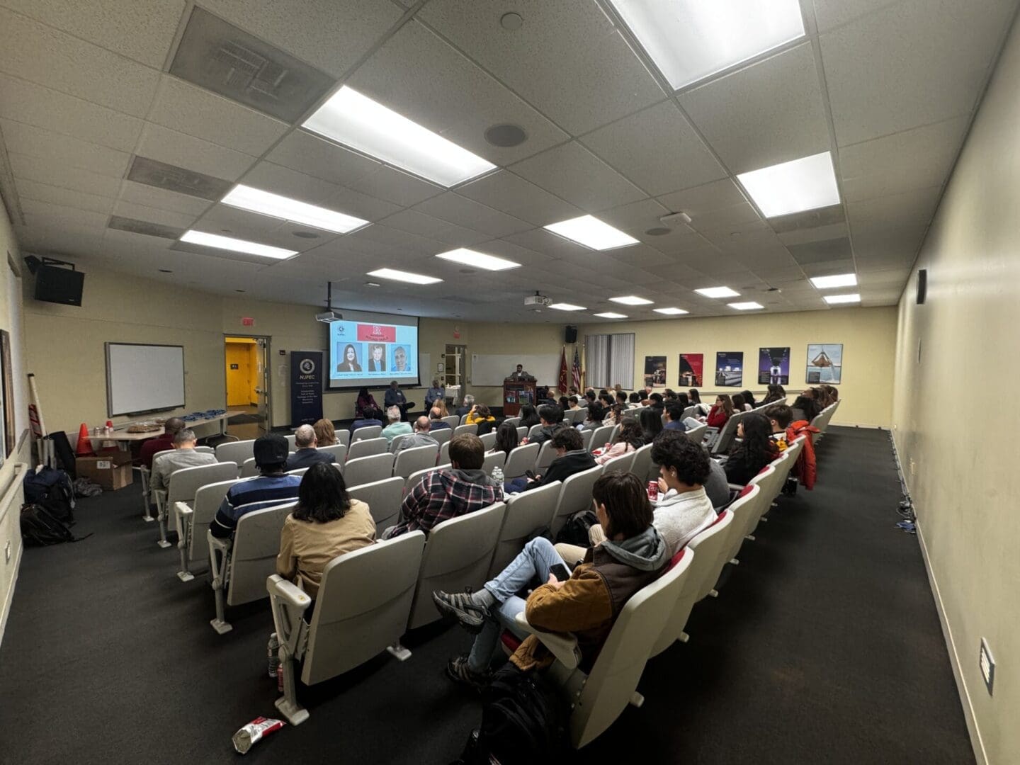 Audience listening to a presentation in classroom.