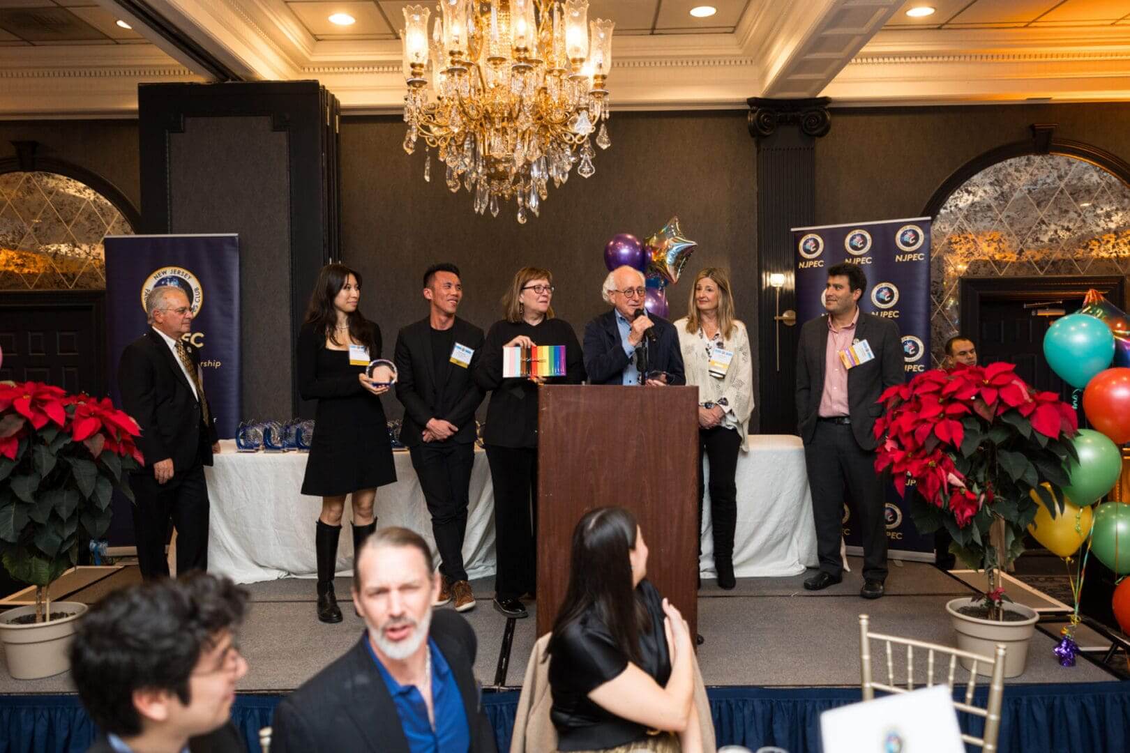 Event speakers at a festive gathering.