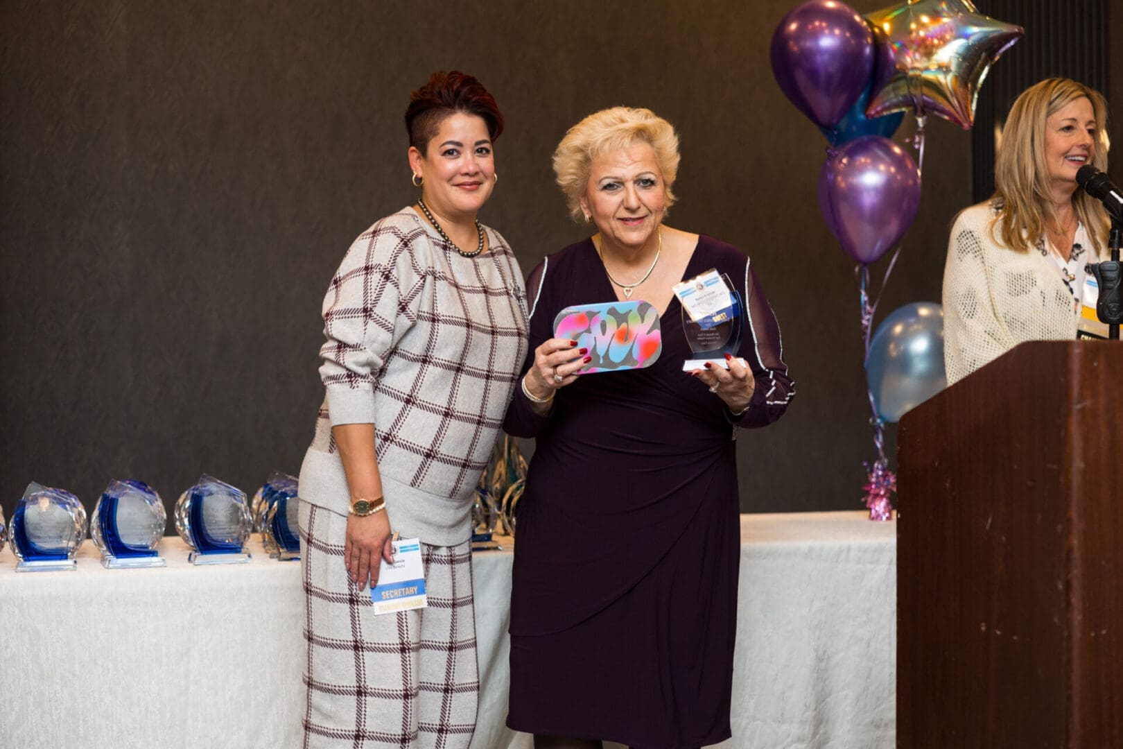 Two women at an award ceremony event.