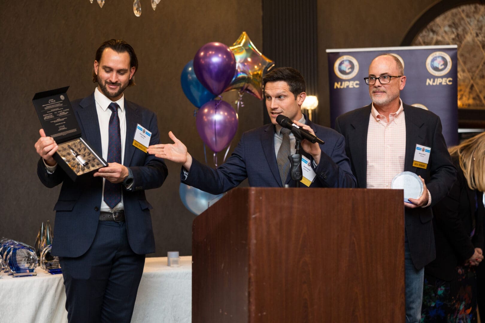 Award ceremony with speakers and attendees.
