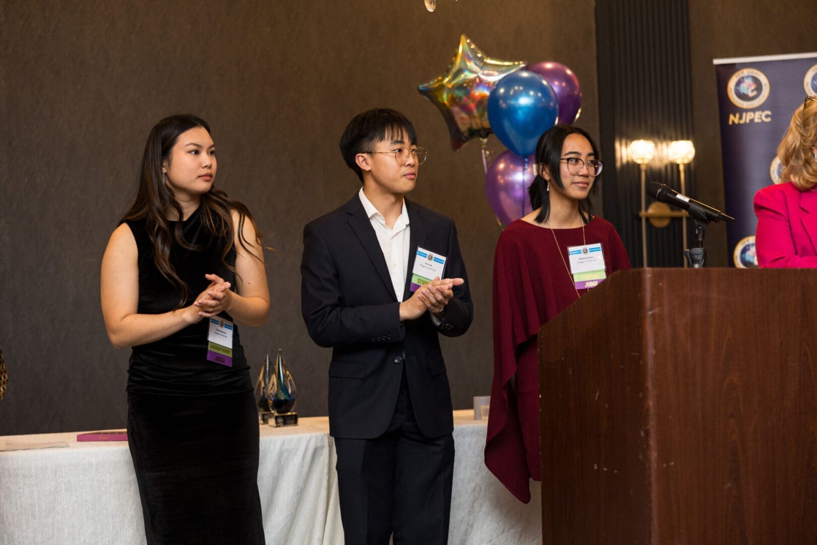 Three individuals at an awards event.