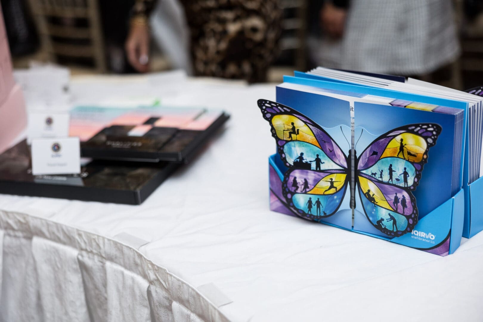 Colorful butterfly artwork on a display table.