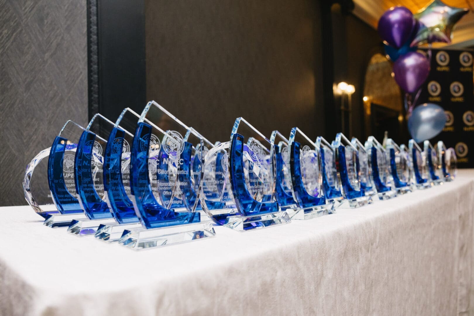 Awards displayed on a table with balloons.