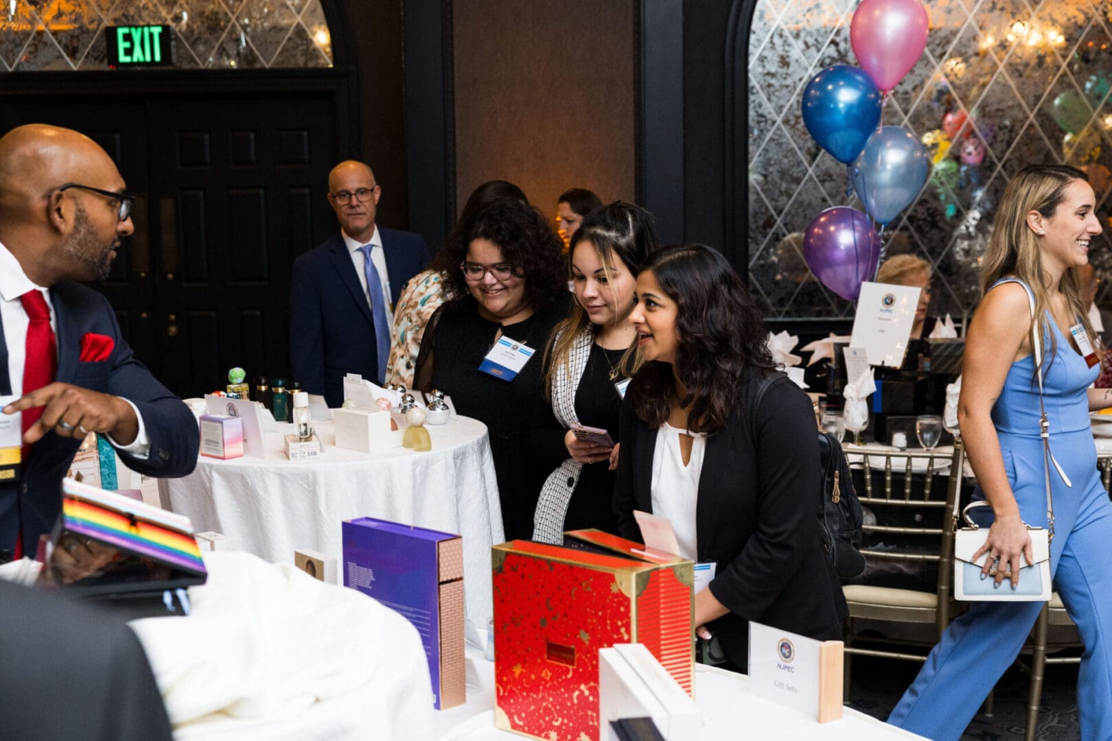 People enjoying an event with gift items.
