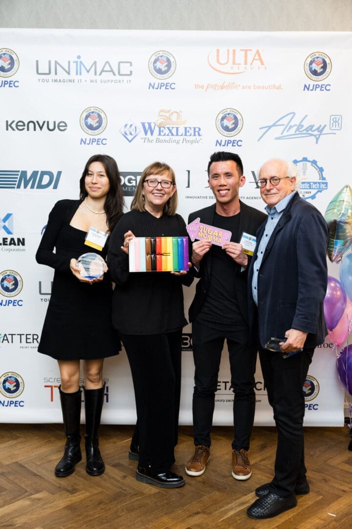 Group celebrating with awards and colorful items.