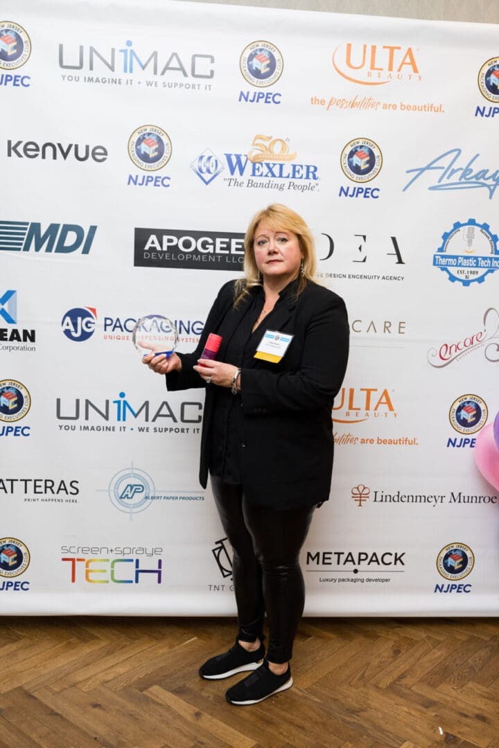 Woman holding an award at an event.