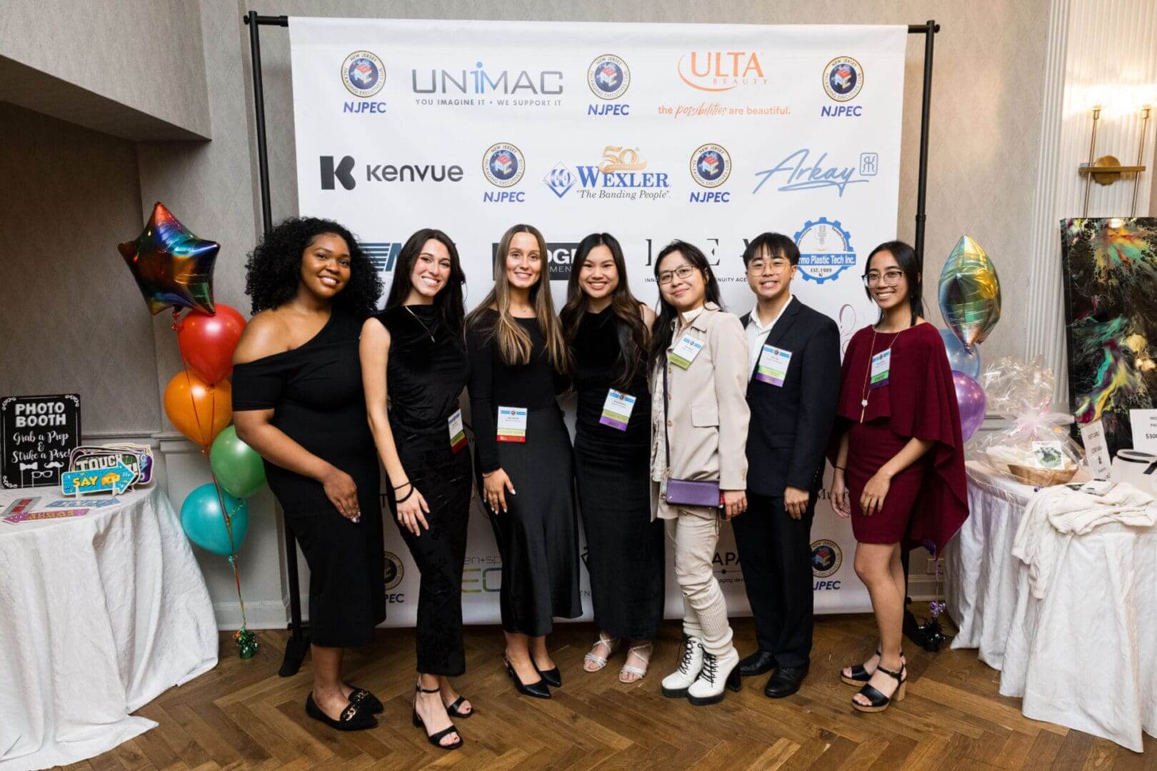 Group photo at a formal event backdrop.