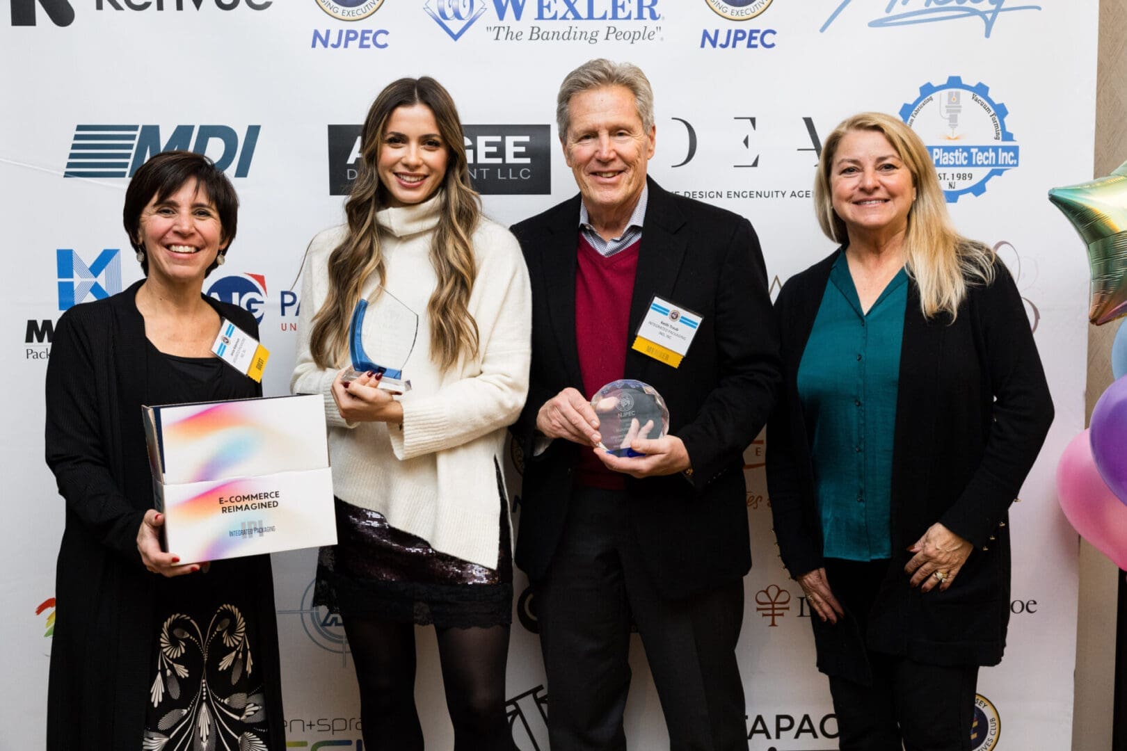 Awards ceremony with four smiling participants.