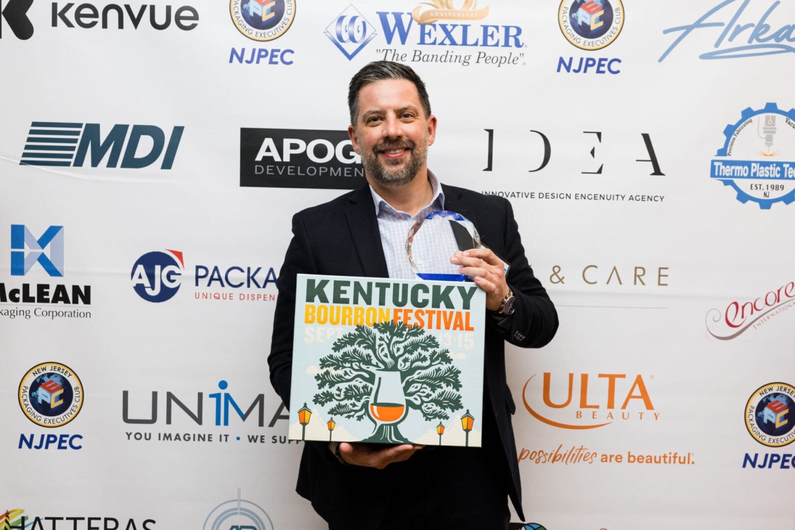 Man holding Kentucky Bourbon Festival sign and award.