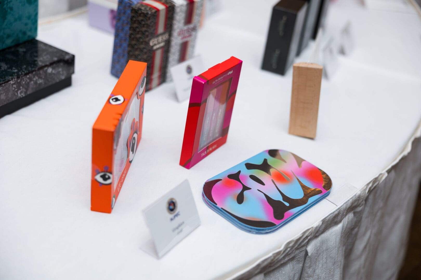 Colorful cosmetic packaging on a display table.