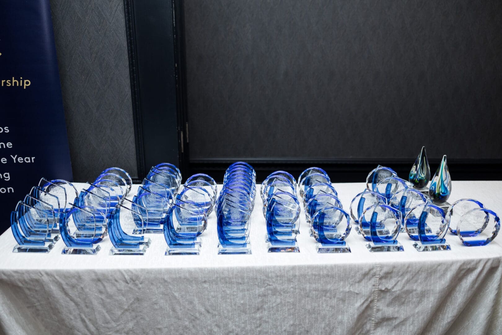 Awards displayed on a table with blue accents.