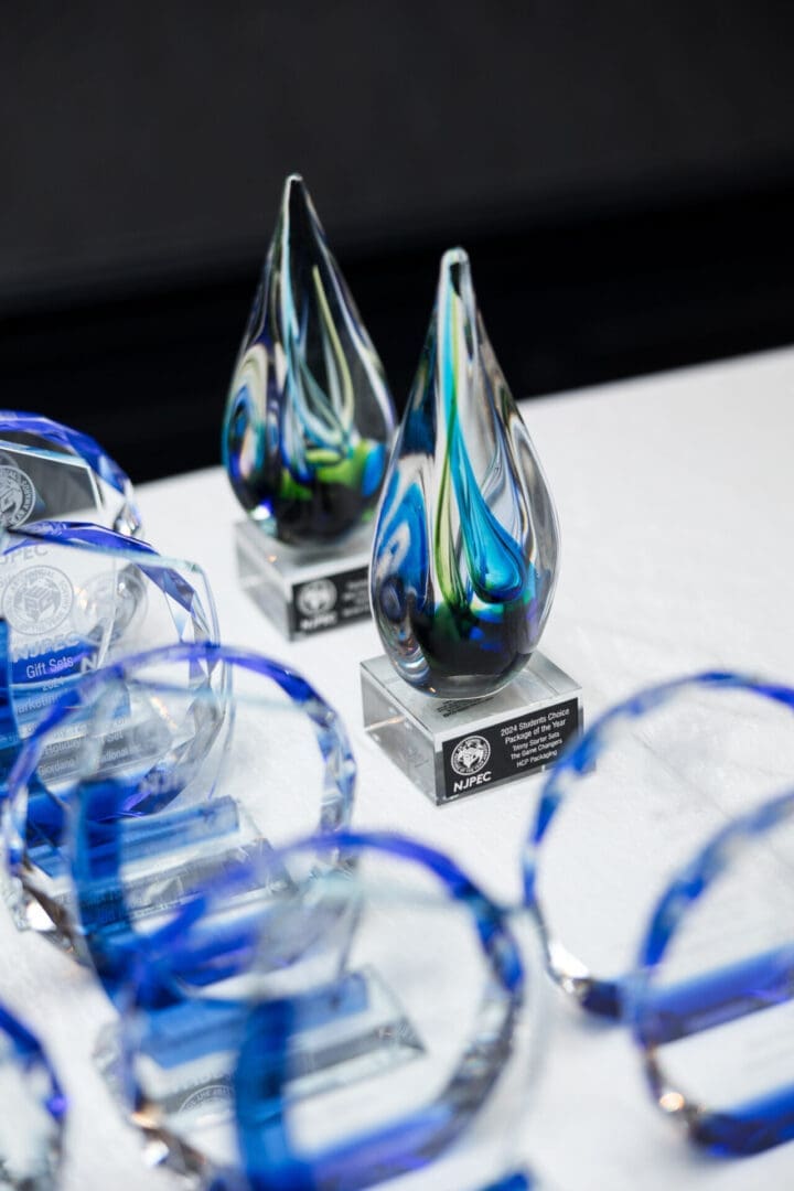 Colorful glass awards displayed on a table.
