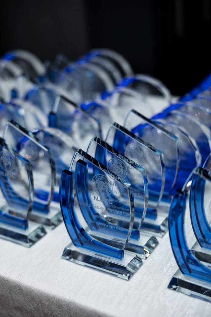 Blue glass awards arranged on a table.