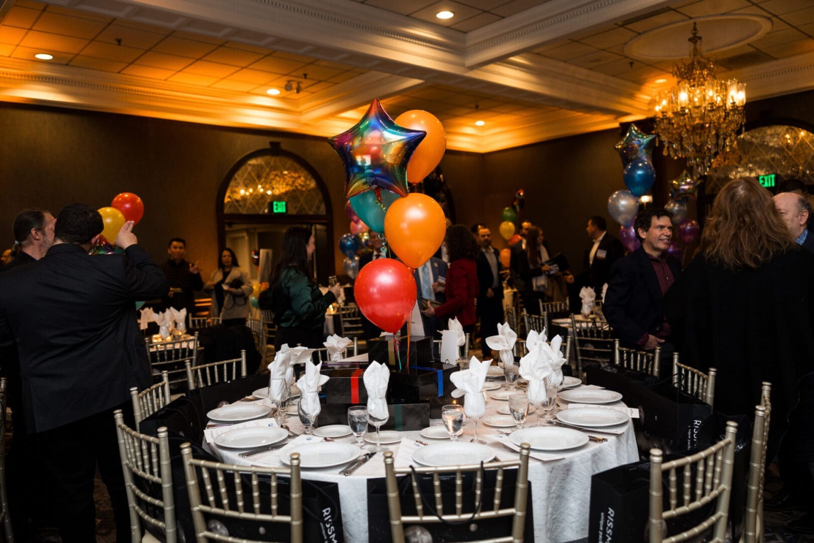 Event venue decorated with balloons and tables.