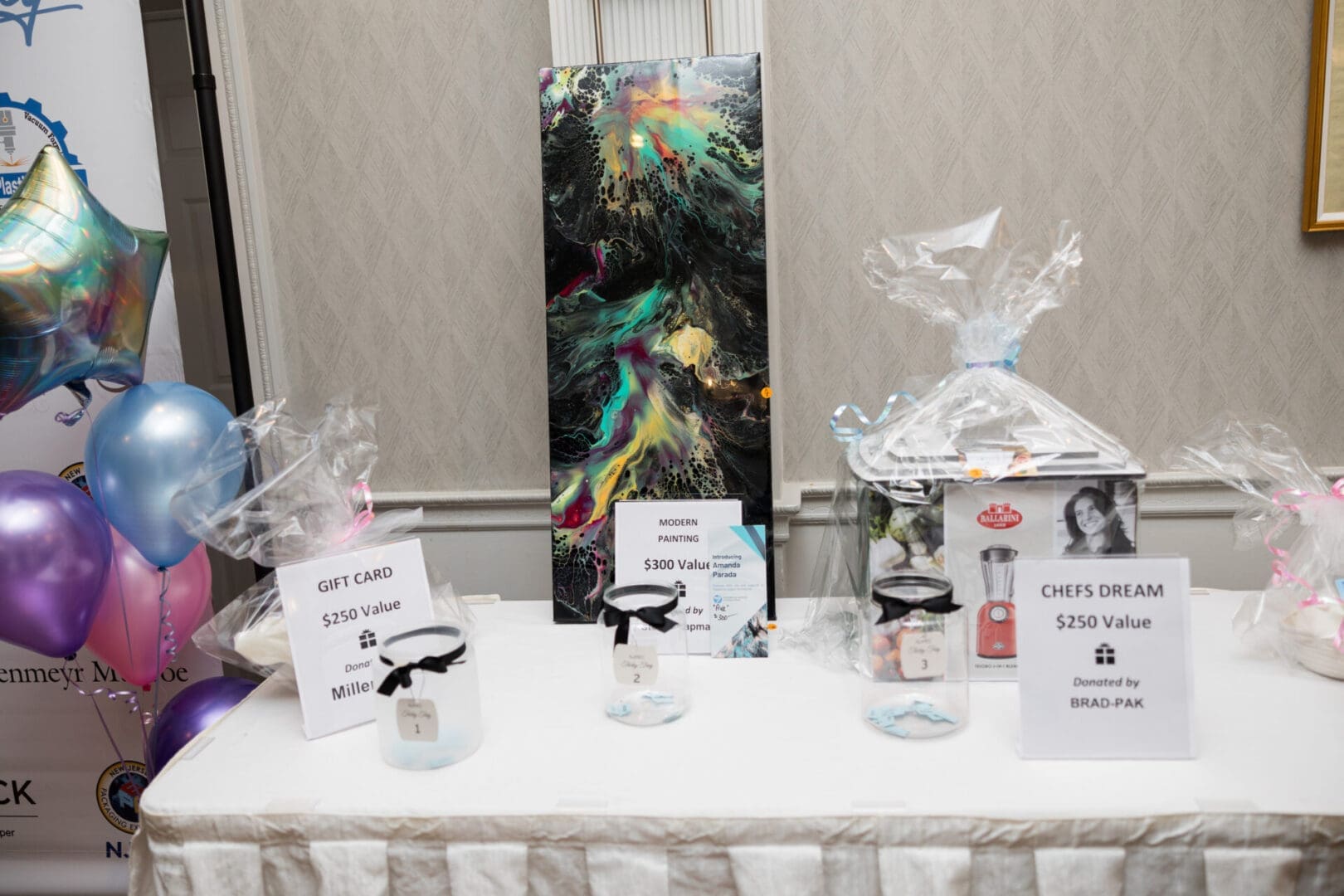 Charity auction items displayed on a table.