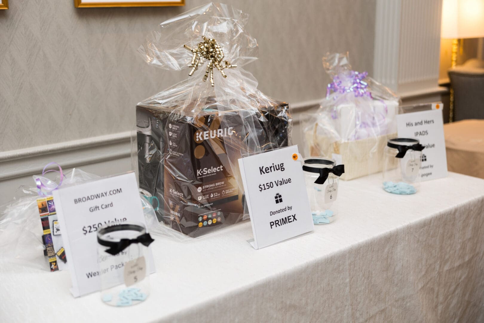 Charity auction items displayed on table.