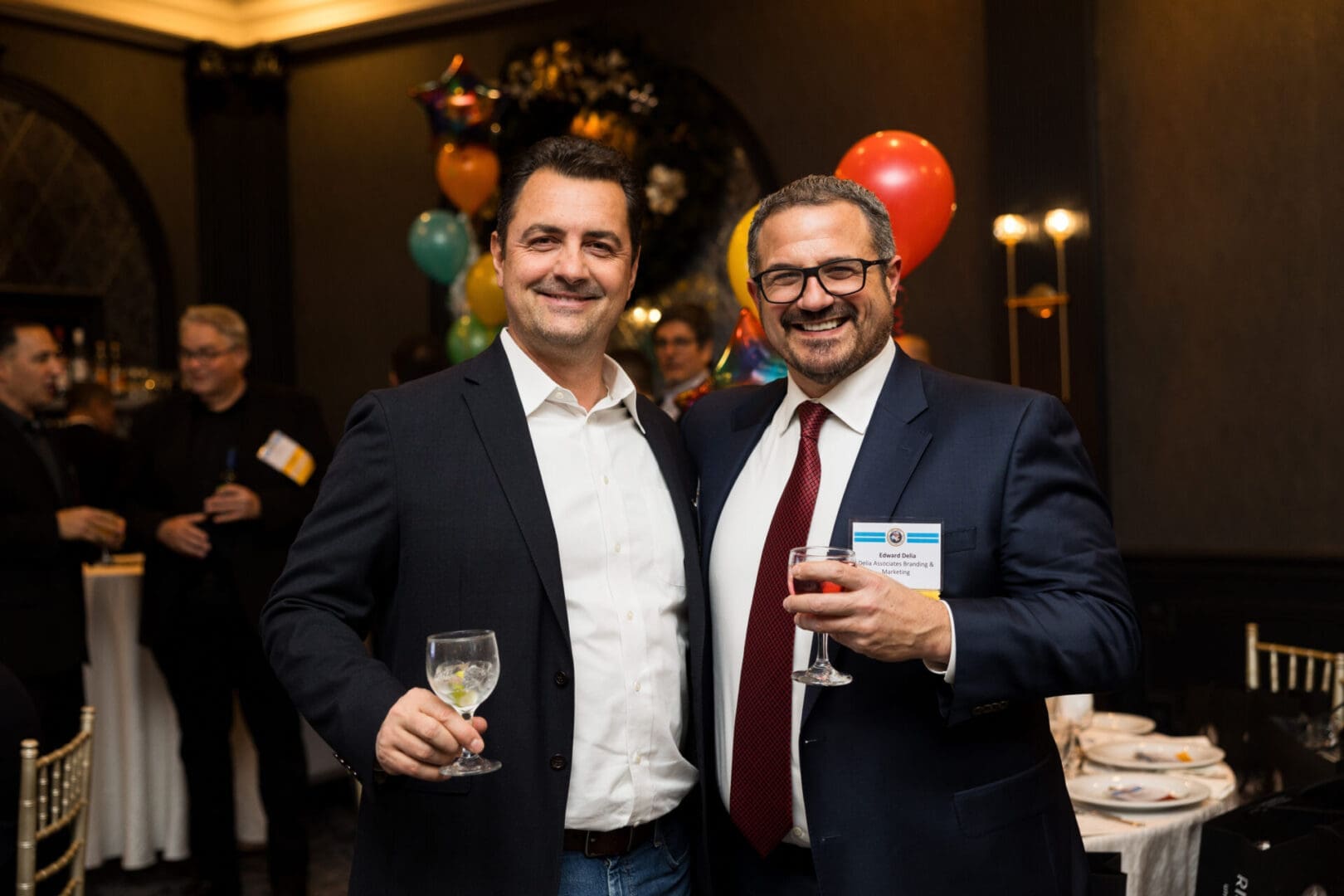 Two men smiling at a celebration event.