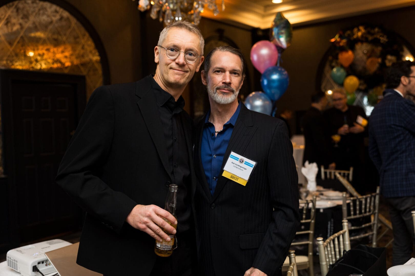 Two men posing at a celebration event.