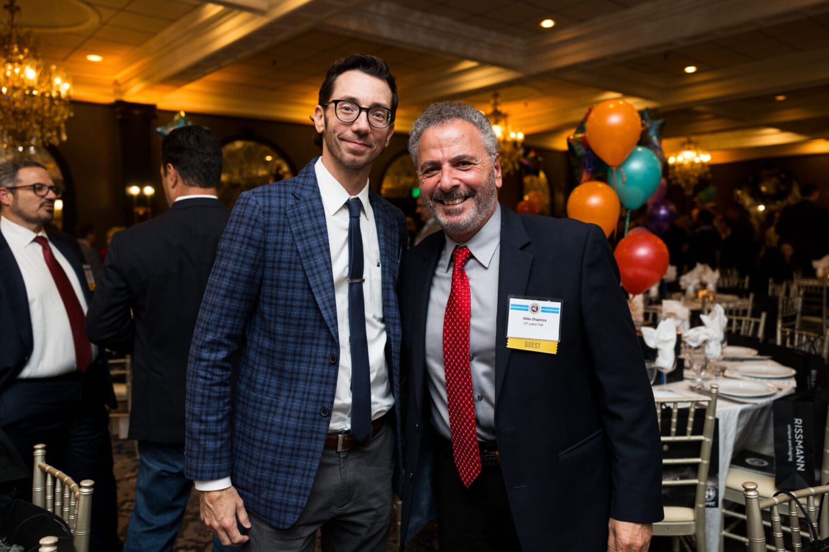 Two men posing at a festive event.