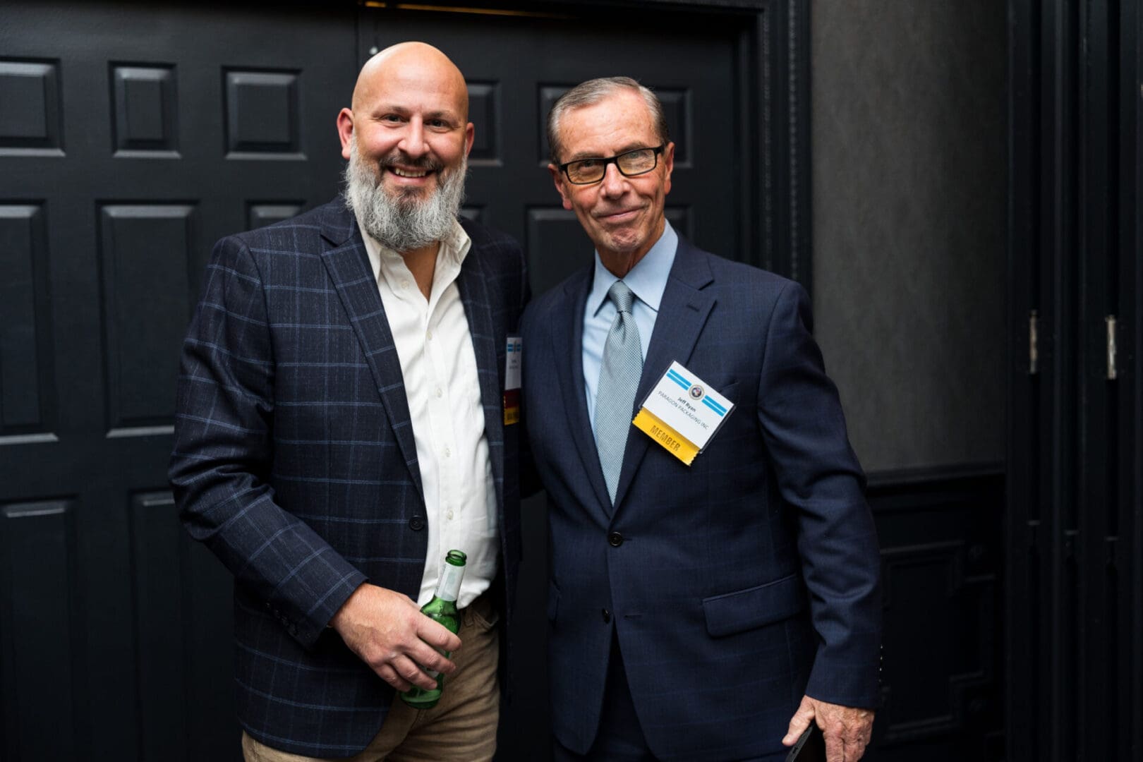 Two men posing together at an event.