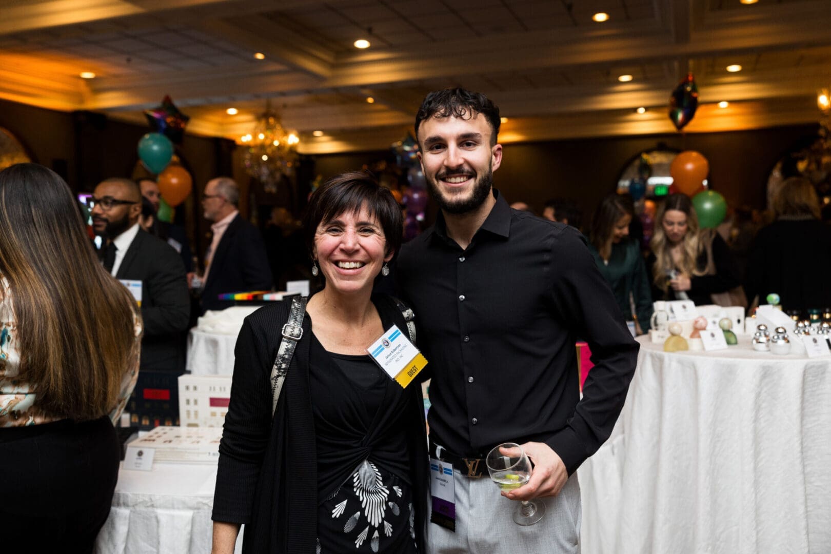 Two smiling people at a social gathering.