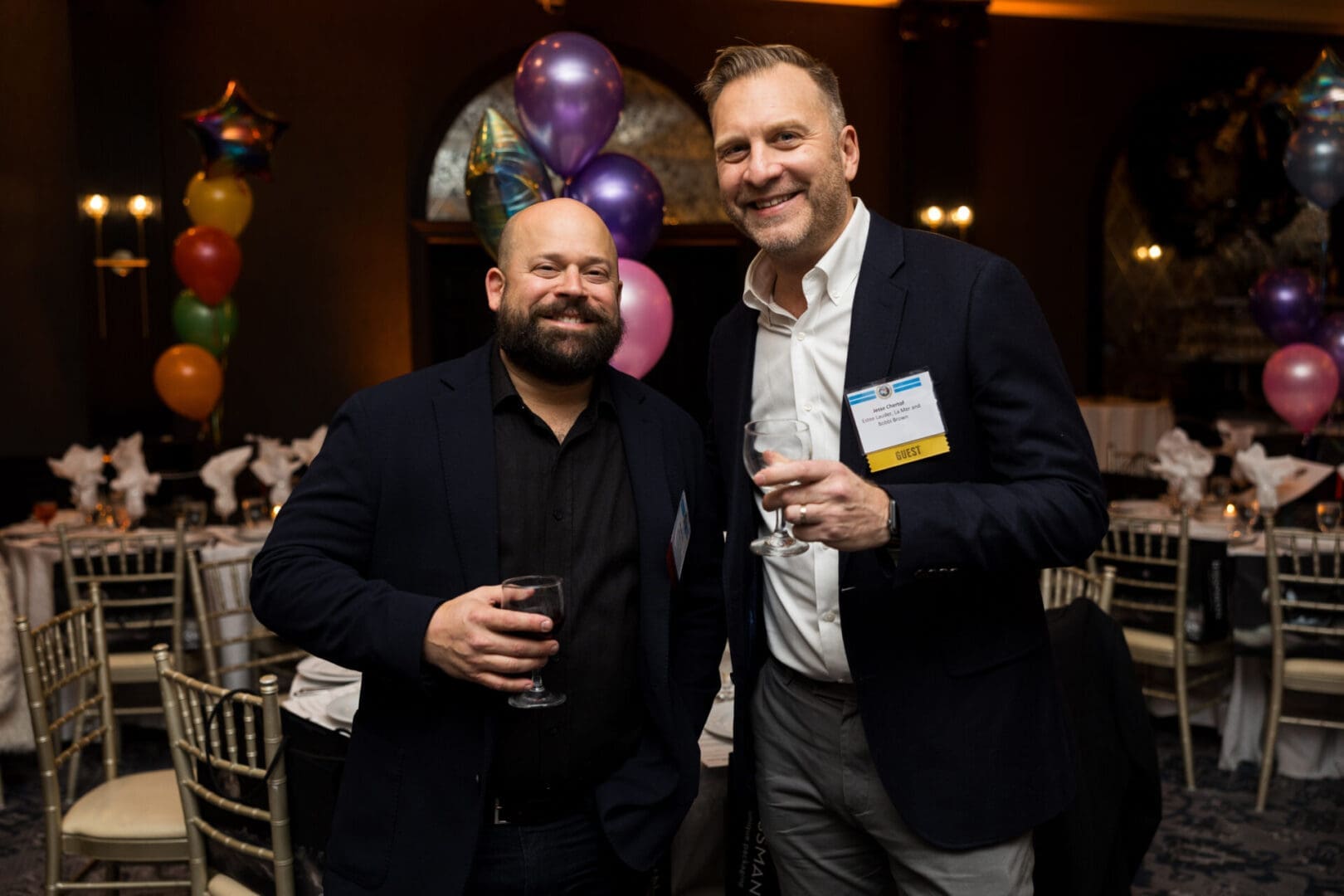Two men smiling at a celebration event.
