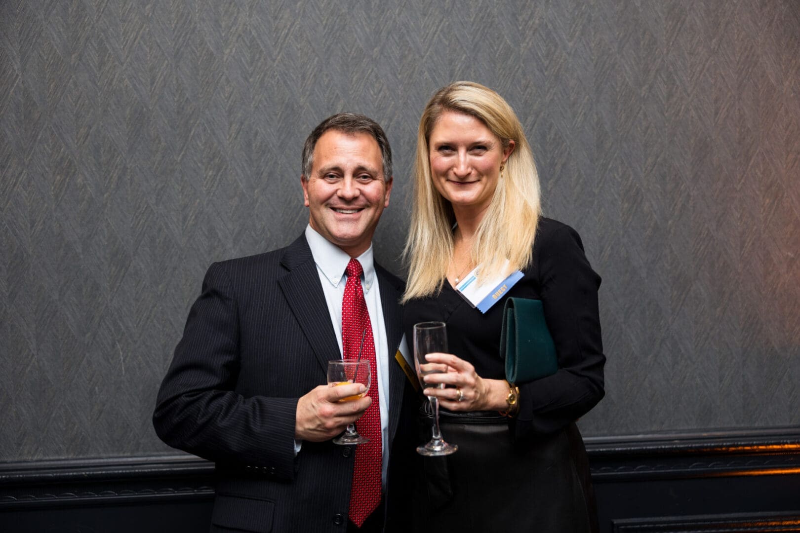 Two people smiling at a formal event.