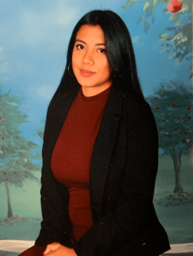 Woman in red dress, outdoor background.